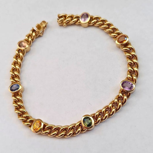 Gold bracelet with embedded colorful gemstones