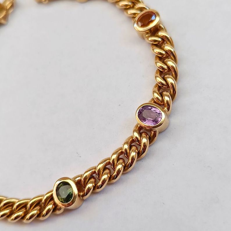 Gold chain bracelet with embedded gemstones