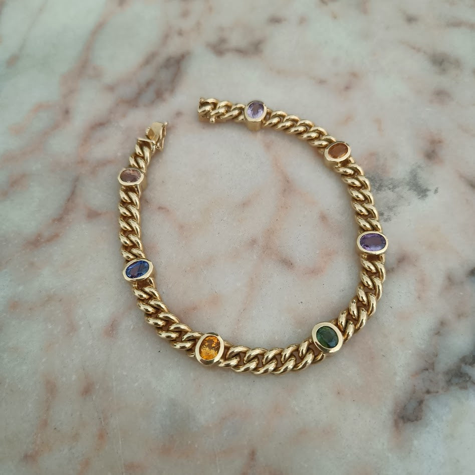 Gold chain bracelet with embedded gemstones