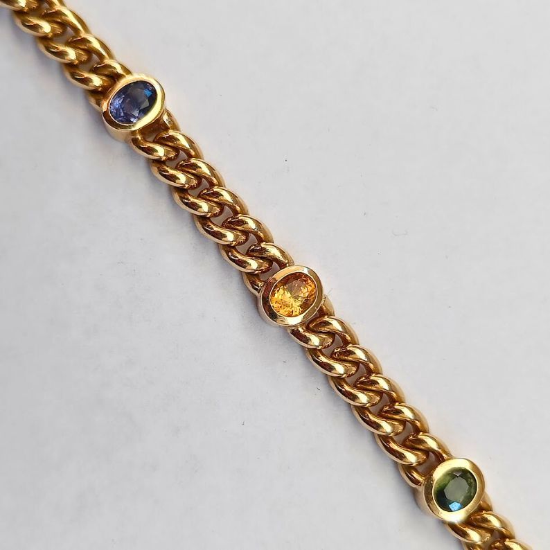 Gold chain bracelet with embedded gemstones